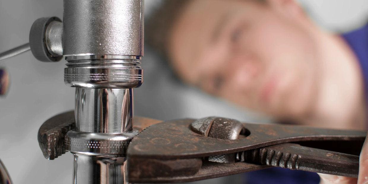 Plumber Doing Some Work Under the Sink