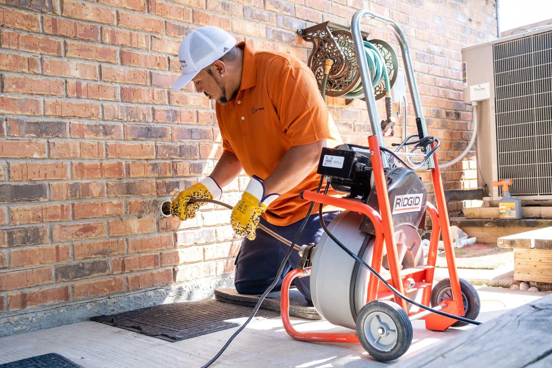 Plumber using a Ridgid drain snake.