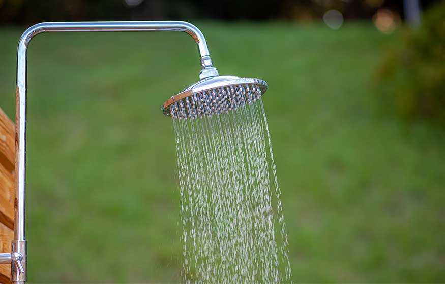 Outdoor shower head stick on the wooden plate pole