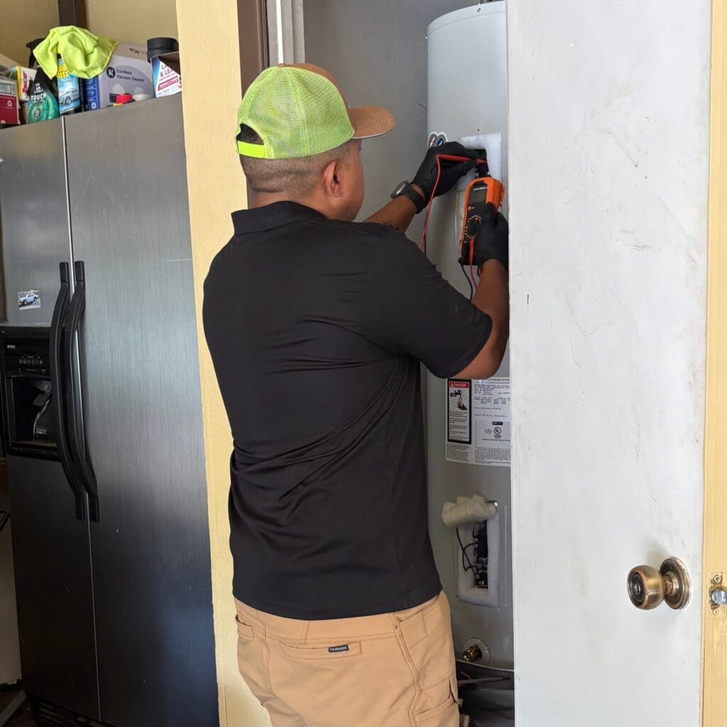 water heater repair service arlington tx plumber inspecting unit with multimeter